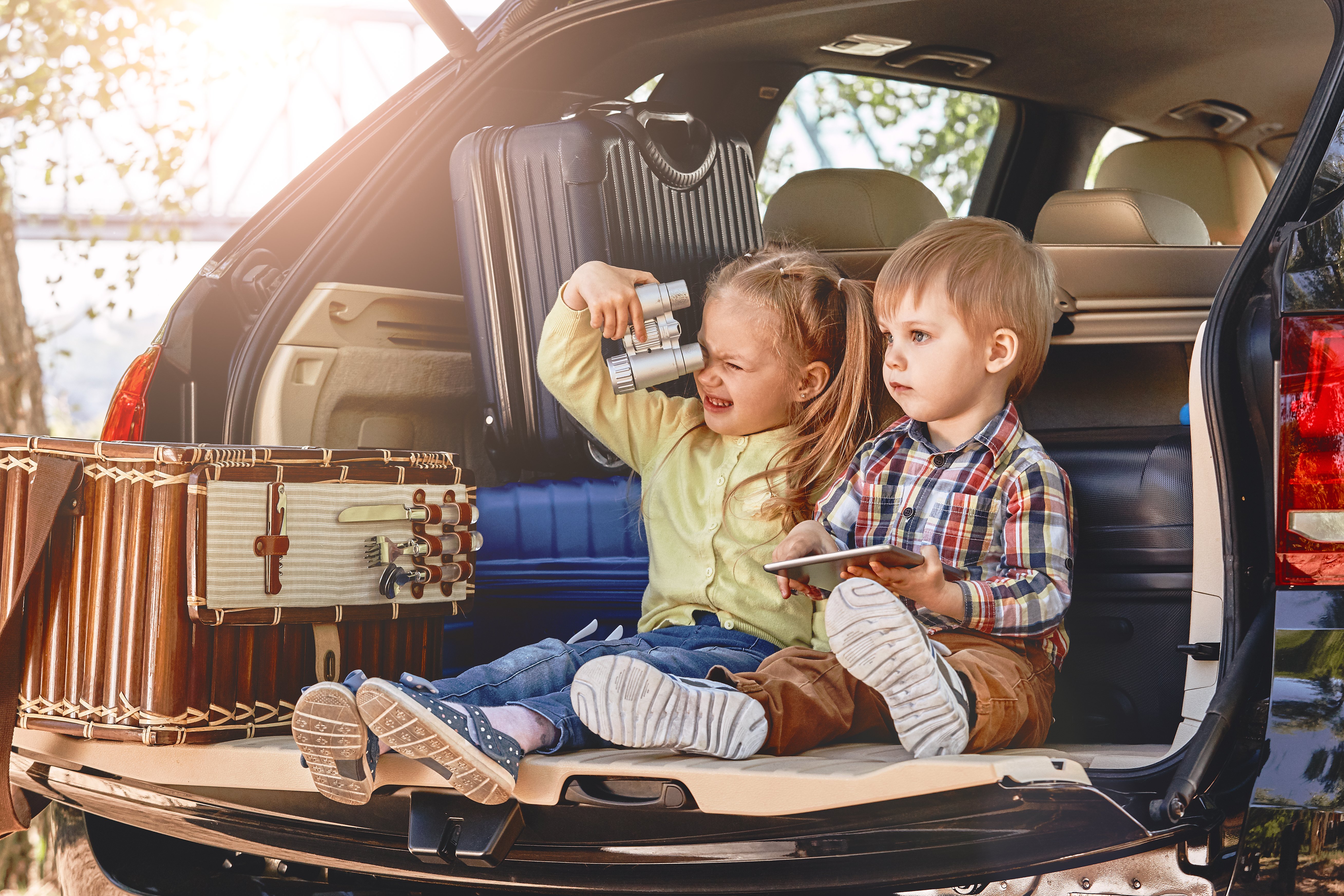 little-cute-kids-having-fun-in-the-trunk-of-a-car-2021-12-09-04-17-59-utc