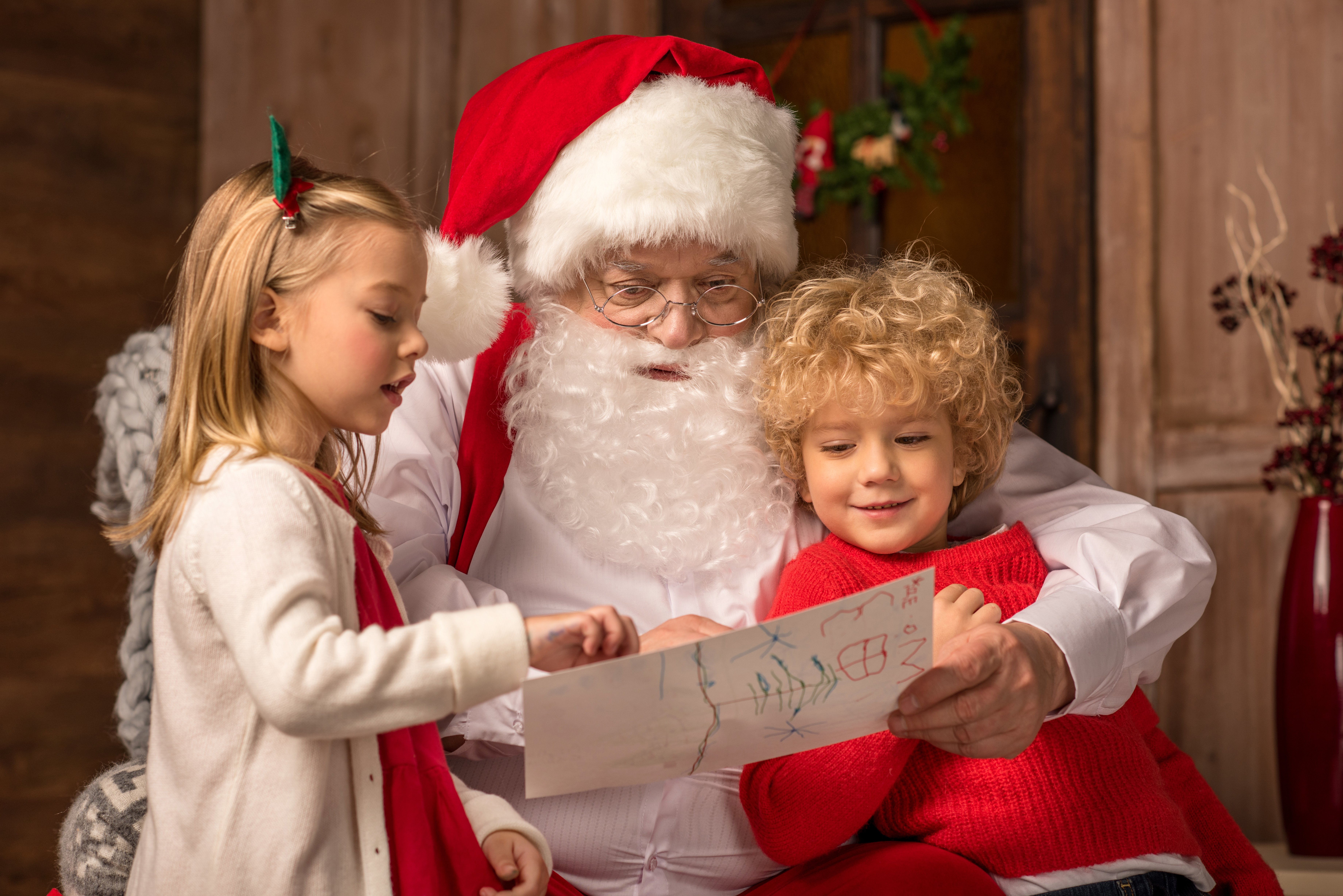 portrait-of-happy-children-showing-picture-to-sant-2022-11-03-03-46-41-utc