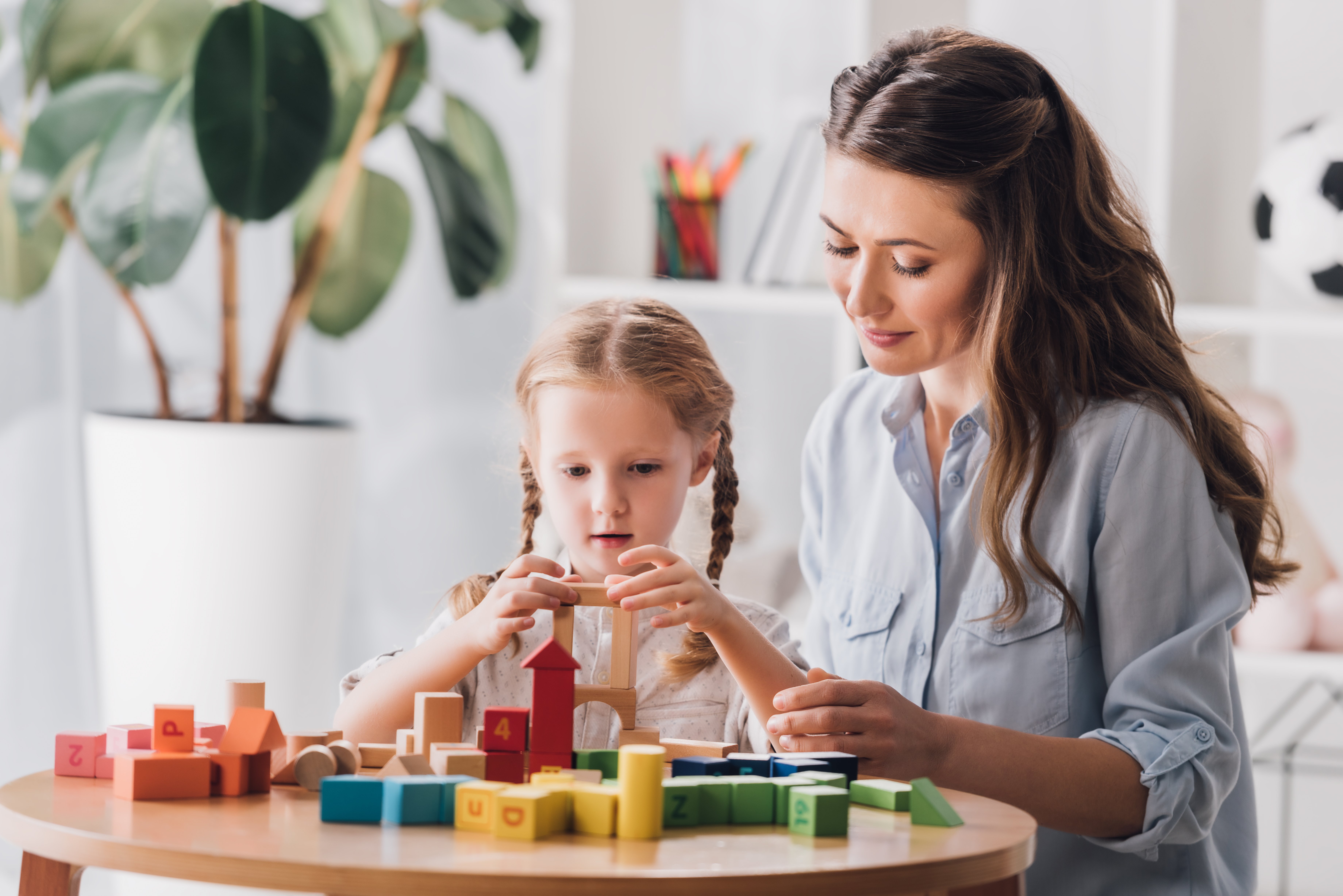 psychologist-playing-blocks-with-little-child-with-2022-12-16-20-46-38-utc